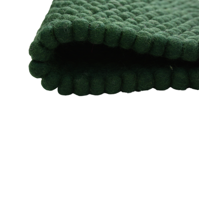 Tapis en laine feutrée vert foncé fait main avec boules
